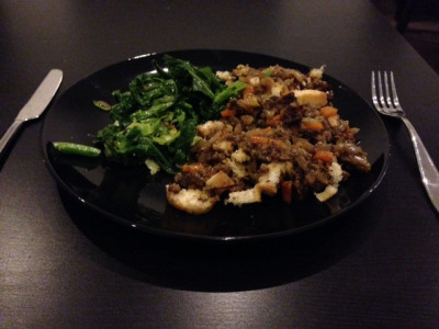Pseudo-meat pie (with carrots, onions and celery) served with garlic spring greens