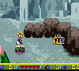 Rayman traversant une étendue d'eau sur une prune.