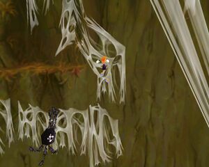 Une araignée géante pourchassant Rayman dans la Canopée.