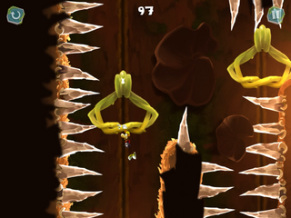 Rayman s'accrochant à une poignée pour éviter des pointes acérées.