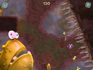 Rayman tombant à côté d'un un Crapaud vert.