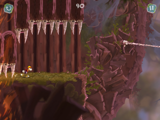 Rayman courant sous des pointes en train de tomber.