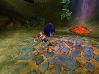 Rayman portant une prune.