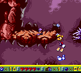 A stone man throwing its head at Rayman.