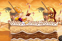 Rayman ducking to avoid a vampire cake's projectile.