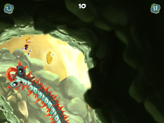 Rayman jumping over a spiky snake in the Rabbit Hole