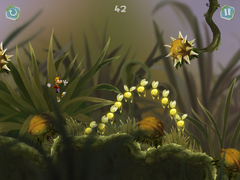 Rayman jumping through open and closed spiky flowers.